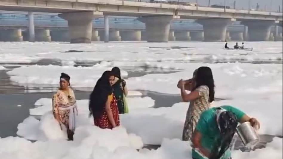 The viral video showed the woman bathing in the Yamuna River despite the toxic foam floating around her. She even used the froth as soap to wash her hair. The viral video showed the woman bathing in the Yamuna River despite the toxic foam floating around her. She even used the froth as soap to wash her hair.