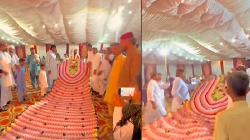 A groom in Bhakkar, Punjab, was seen wearing a massive 35-foot-long garland made entirely of currency notes during his wedding celebration. A groom in Bhakkar, Punjab, was seen wearing a massive 35-foot-long garland made entirely of currency notes during his wedding celebration.