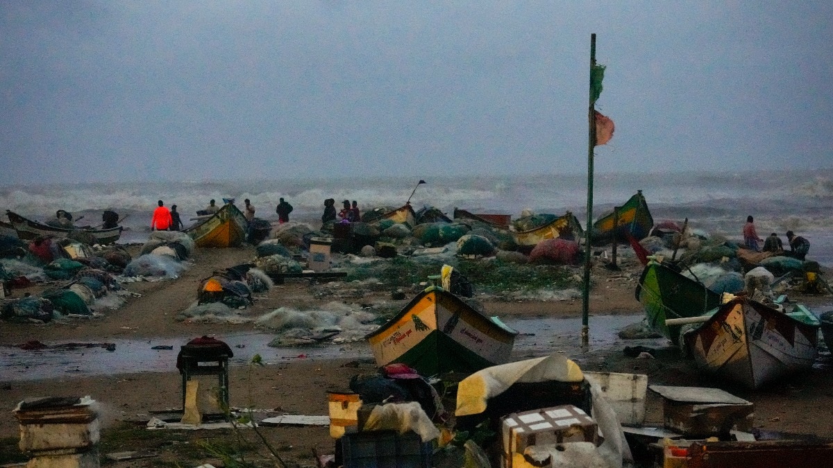 Visitors brave strong winds at the Marina beach, in Chennai, on November 30. Visitors brave strong winds at the Marina beach, in Chennai, on November 30.