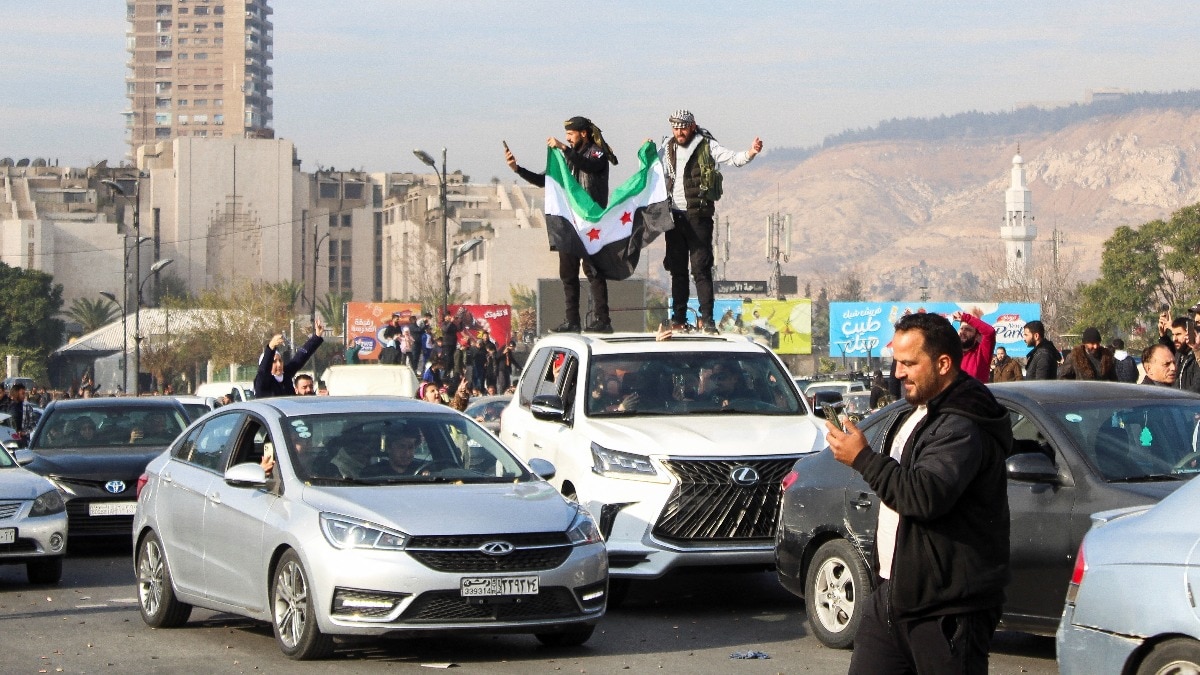 Men hold a Syrian opposition flag on the top of a vehicle as people celebrate after Syrian rebels announced that they have ousted President Bashar al-Assad in Damascus on December 8. Men hold a Syrian opposition flag on the top of a vehicle as people celebrate after Syrian rebels announced that they have ousted President Bashar al-Assad in Damascus on December 8.
