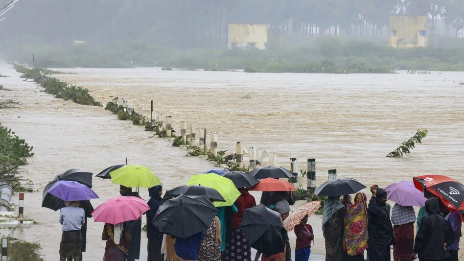 People watch as Seevalaperi river swells following heavy rains in Tirunelveli on December 14. People watch as Seevalaperi river swells following heavy rains in Tirunelveli on December 14.