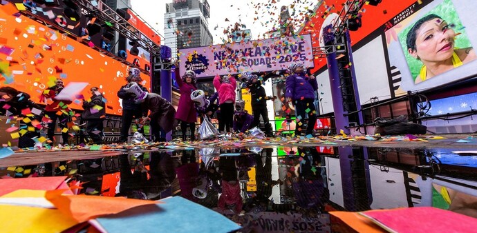 People throw confetti on a platform while organizers of the upcoming ball drop on New Year's Eve do a confetti test in Times Square, New York. People throw confetti on a platform while organizers of the upcoming ball drop on New Year's Eve do a confetti test in Times Square, New York.