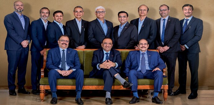 Dinesh Kanabar (centre), CEO of Dhruva Advisors, with colleagues. Photo by : Milind Shelte Dinesh Kanabar (centre), CEO of Dhruva Advisors, with colleagues. Photo by : Milind Shelte