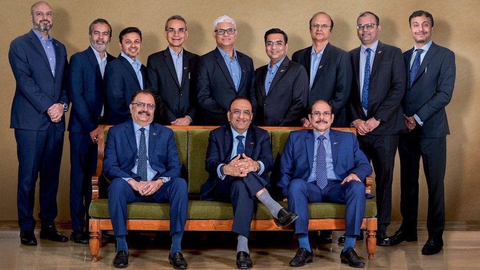 Dinesh Kanabar (centre), CEO of Dhruva Advisors, with colleagues. Photo by : Milind Shelte Dinesh Kanabar (centre), CEO of Dhruva Advisors, with colleagues. Photo by : Milind Shelte