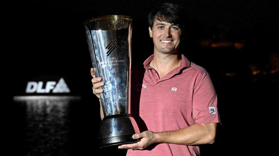 Ollie Schniederjans with his International Series India presented by DLF trophy in Gurgaon on Sunday. (Image courtesy: Asian Tour) Ollie Schniederjans with his International Series India presented by DLF trophy in Gurgaon on Sunday. (Image courtesy: Asian Tour)