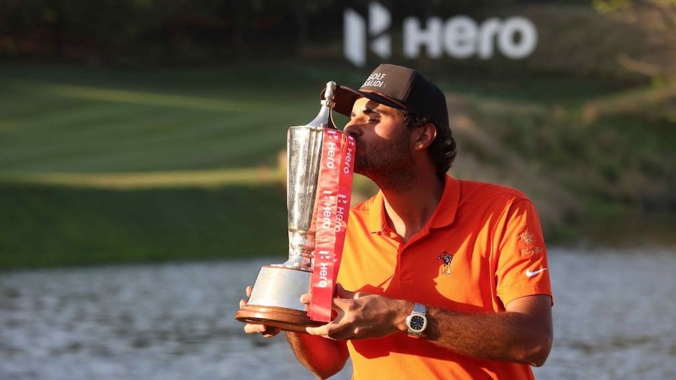 Hero Indian Open 2025 champion Eugenio Chacarra of Spain celebrates with his trophy at the DLF Golf and Country Club in Gurgaon on Sunday. (Image courtesy: HIO) Hero Indian Open 2025 champion Eugenio Chacarra of Spain celebrates with his trophy at the DLF Golf and Country Club in Gurgaon on Sunday. (Image courtesy: HIO)