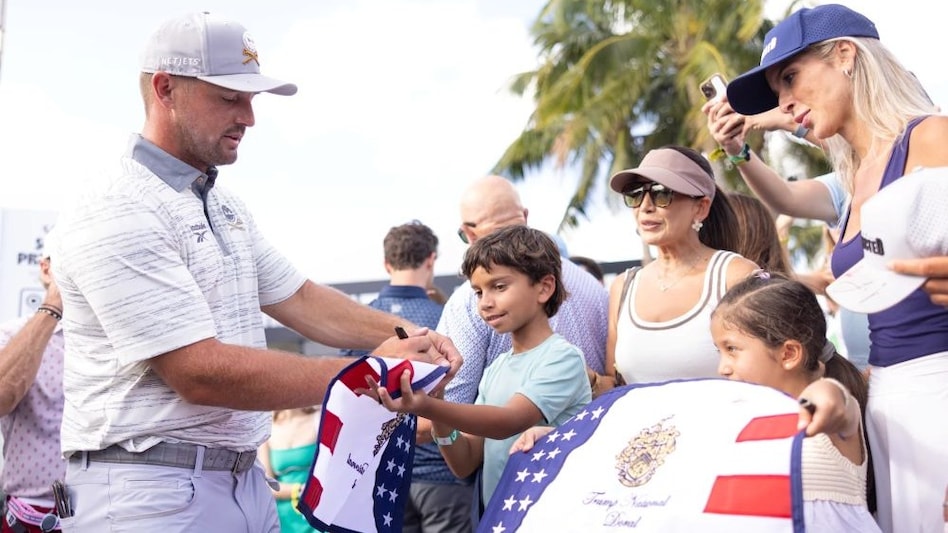 Crushers GC captain Bryson DeChambeau interacts with a young fan on his way into the day two LIV Golf Miami lead on Saturday. (Image courtesy: LIV Golf) Crushers GC captain Bryson DeChambeau interacts with a young fan on his way into the day two LIV Golf Miami lead on Saturday. (Image courtesy: LIV Golf)