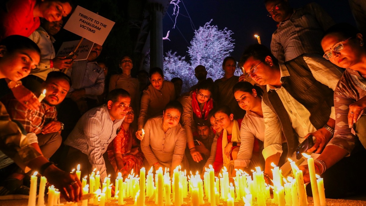 Members of C G Road Shop Owners' Association with locals hold a candlelight vigil to pay tribute to the victims of terrorist attack in J&K's Pahalgam, in Ahmedabad on April 24.