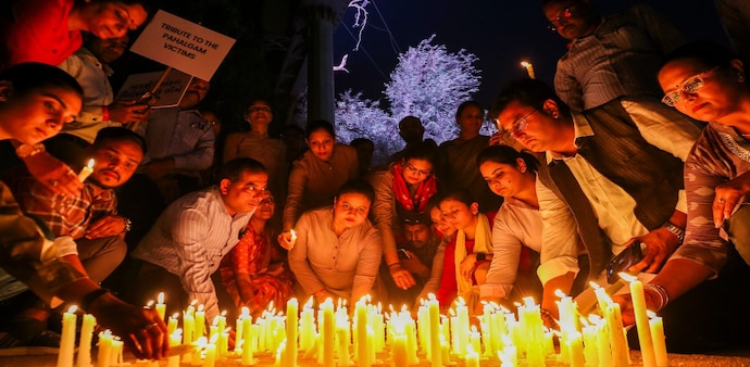 Members of C G Road Shop Owners' Association with locals hold a candlelight vigil to pay tribute to the victims of terrorist attack in J&K's Pahalgam, in Ahmedabad on April 24. Members of C G Road Shop Owners' Association with locals hold a candlelight vigil to pay tribute to the victims of terrorist attack in J&K's Pahalgam, in Ahmedabad on April 24.