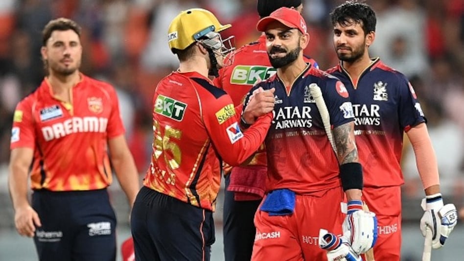 Royal Challengers Bengaluru's Virat Kohli (2R) is congratulated by Punjab Kings' Josh Inglis (2L) after their win at the end of the Indian Premier League (IPL) Twenty20 cricket match between Punjab Kings and Royal Challengers Bengaluru Royal Challengers Bengaluru's Virat Kohli (2R) is congratulated by Punjab Kings' Josh Inglis (2L) after their win at the end of the Indian Premier League (IPL) Twenty20 cricket match between Punjab Kings and Royal Challengers Bengaluru