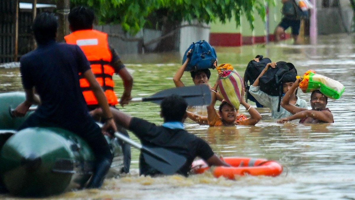 Rescue personnel assist locals in moving to a safer place at a flood-affected area amid rainfall on the outskirts of Agartala, Tripura, on June 1. Rescue personnel assist locals in moving to a safer place at a flood-affected area amid rainfall on the outskirts of Agartala, Tripura, on June 1.