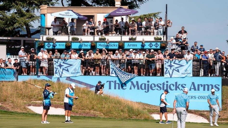 Majesricks co-captains Lee Westwood and Ian Poulter study their putting lines on the ninth green as fans watch from the Majesticks Arms pub during the first round of LIV Golf UK by JCB in Rocester. Image courtesy LIV Golf. Majesricks co-captains Lee Westwood and Ian Poulter study their putting lines on the ninth green as fans watch from the Majesticks Arms pub during the first round of LIV Golf UK by JCB in Rocester. Image courtesy LIV Golf.