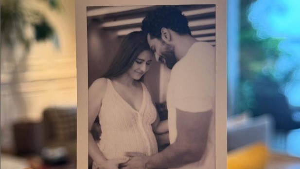 Katrina shared a picture of Kaushal holding a black-and-white photograph