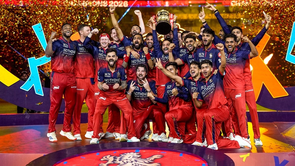 Royal Challengers Bengaluru's players celebrate with the tournament trophy during the presentation ceremony after winning the IPL 2026 title in Ahmedabad on May 31.