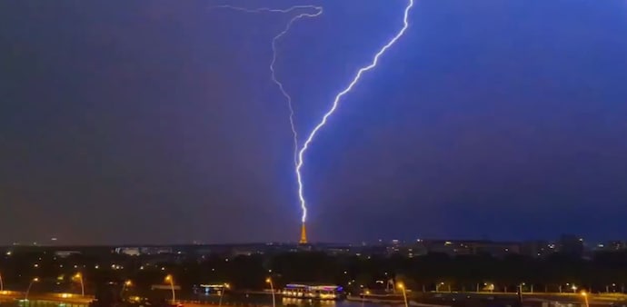 Lightning hits the Eiffel Tower during a thunderstorm in Paris on July 27. The storms are expected to bring an end to one of France’s most extraordinary heatwaves. Lightning hits the Eiffel Tower during a thunderstorm in Paris on July 27. The storms are expected to bring an end to one of France’s most extraordinary heatwaves.
