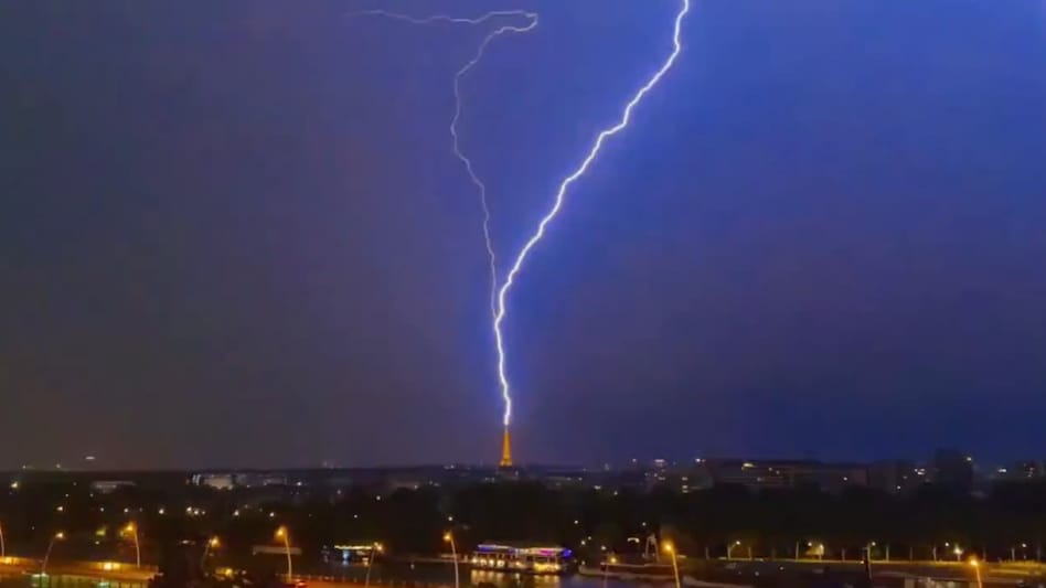 Lightning hits the Eiffel Tower during a thunderstorm in Paris on July 27. The storms are expected to bring an end to one of France’s most extraordinary heatwaves. Lightning hits the Eiffel Tower during a thunderstorm in Paris on July 27. The storms are expected to bring an end to one of France’s most extraordinary heatwaves.