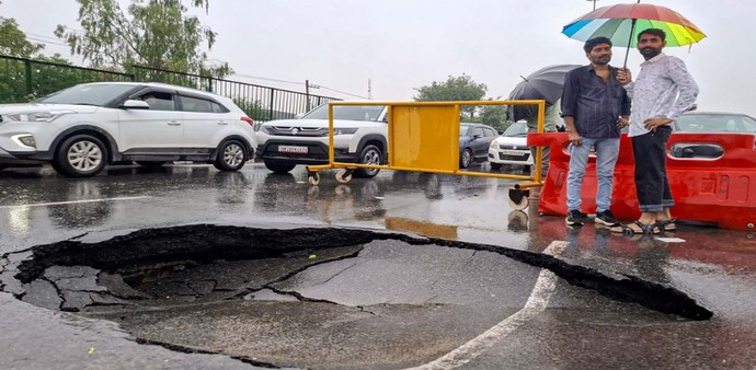 Gurugram: caved-in section of a road following monsoon rains (PTI Photo) Gurugram: caved-in section of a road following monsoon rains (PTI Photo)