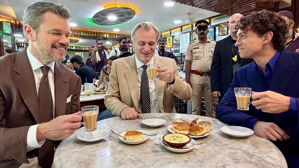 Videos and photographs shared online showed Nolan, Damon and Holland greeting customers before settling down with glasses of chai and freshly prepared bun maska. 