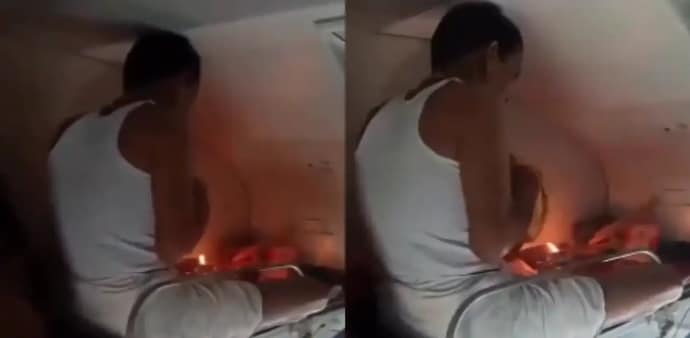 a passenger lighting a Diya and incense sticks while performing prayers inside an AC train coach a passenger lighting a Diya and incense sticks while performing prayers inside an AC train coach