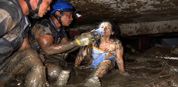 A 60-year-old woman was found alive after spending 10 days trapped beneath mud and debris A 60-year-old woman was found alive after spending 10 days trapped beneath mud and debris