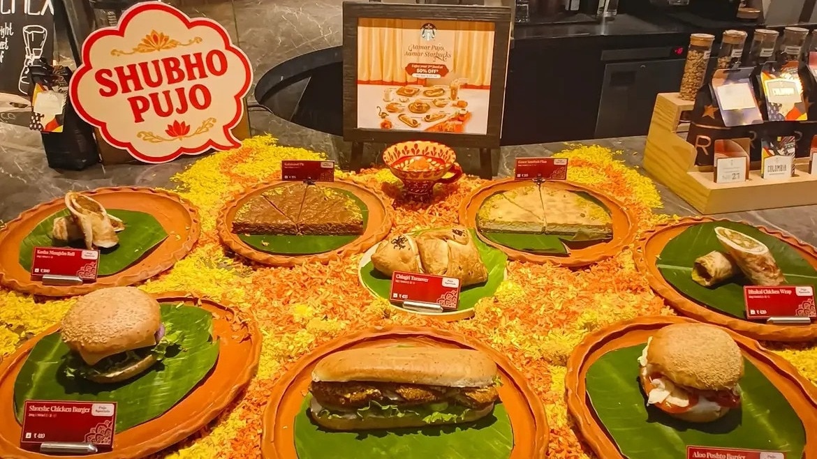 The food menu includes the Shorshe Chicken Burger, Kosha Mangsho Roll, Bhekti Bhaja Sandwich, Dhakai Chicken Wrap, Aloo Postho Burger and Chingri Turnover.