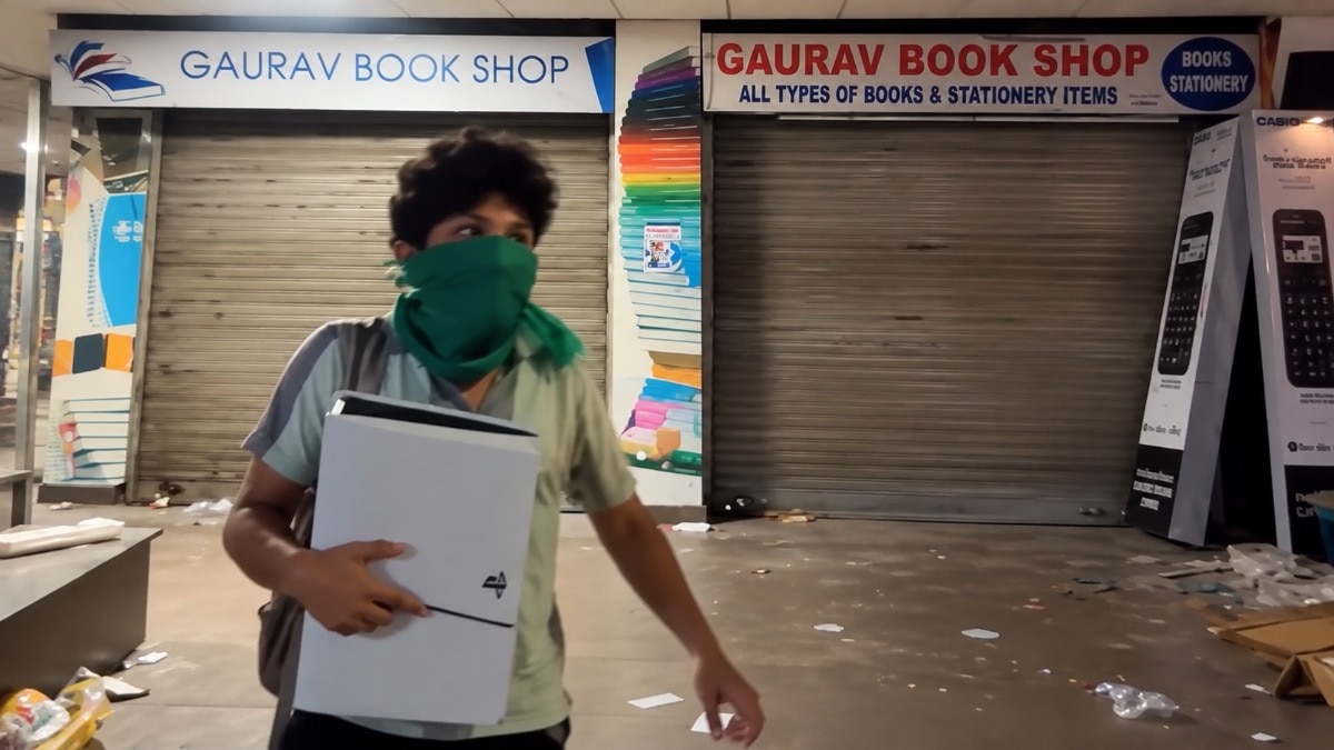 In a viral video, a man was seen carrying away a Sony PS5, even as the stationery and book store remained untouched. (Social Media)