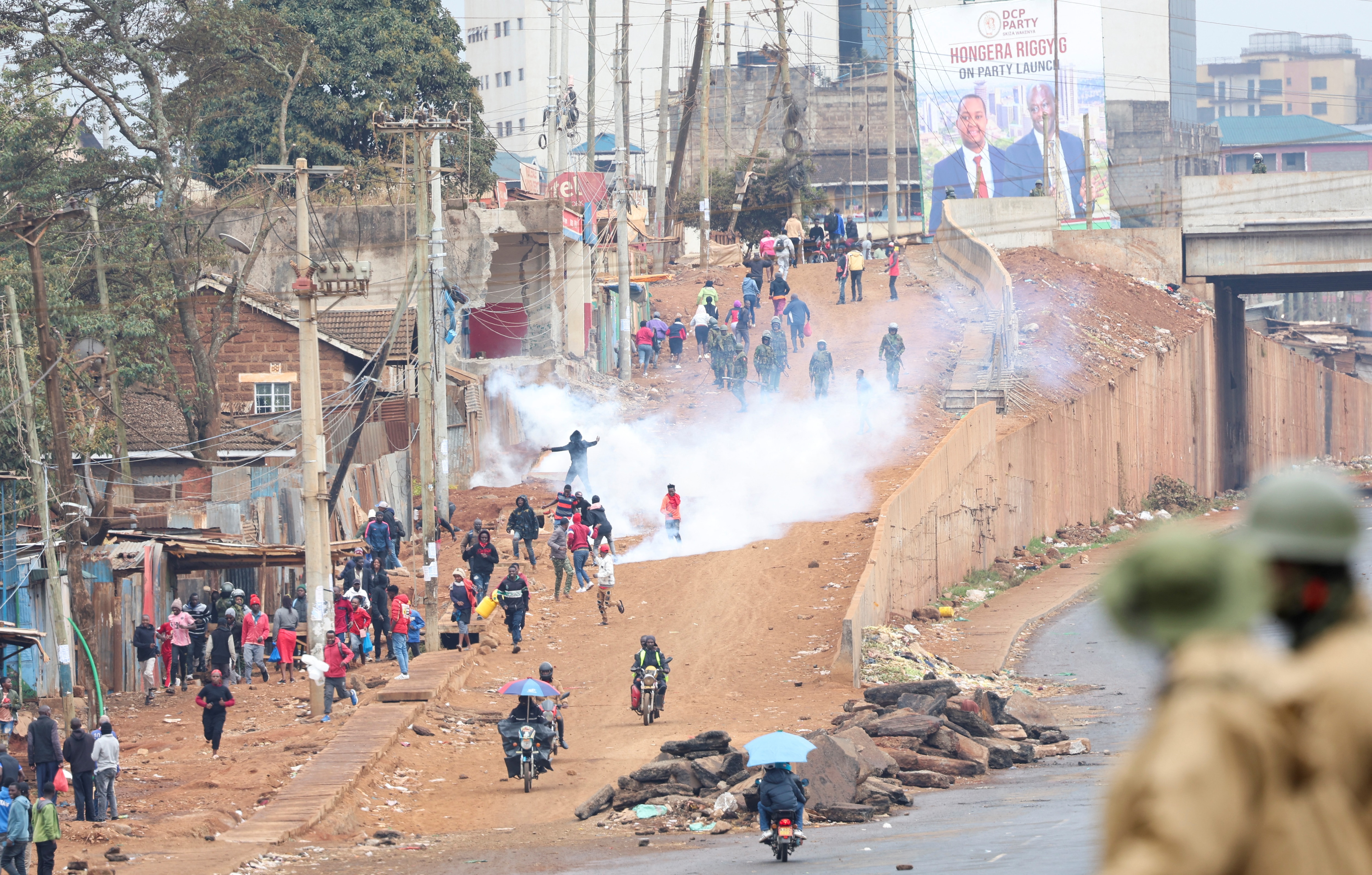 kenya anti-government protests democracy struggle police smoke tear gas running