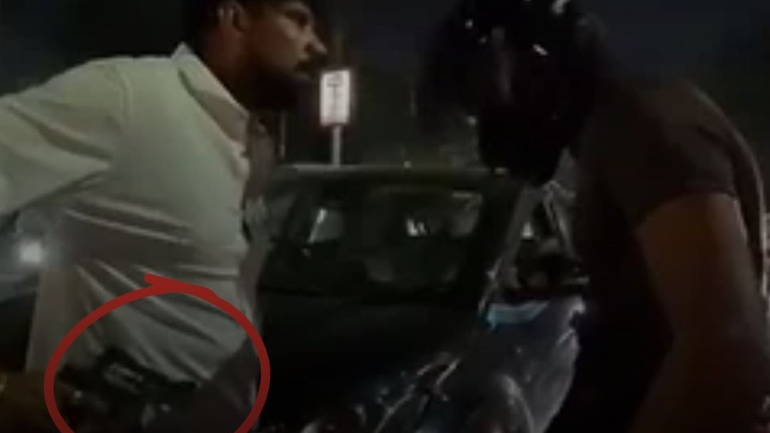 Car driver points pistol at motorcyclist after collision