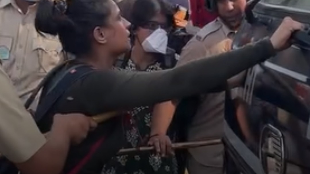 This protester tried to stop a police van. A cop stopped her.