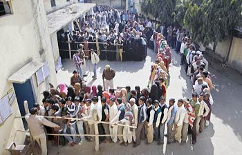 Voters outside a polling station in Amroha