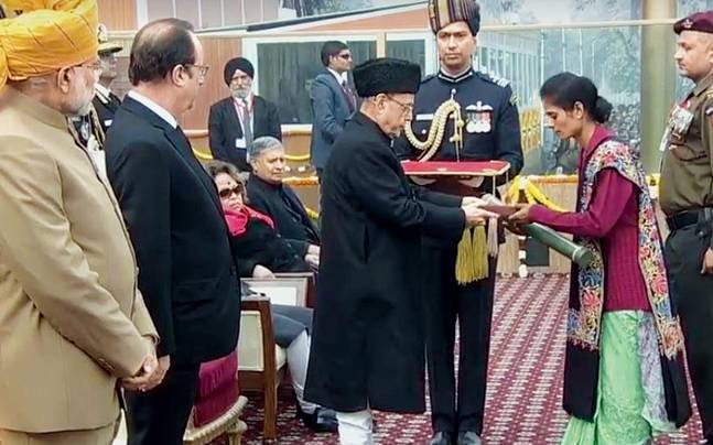 Late Lance Naik Mohan Nath Goswami's widow collects the Ashok Chakra from President Pranab Mukherjee on Republic Day.