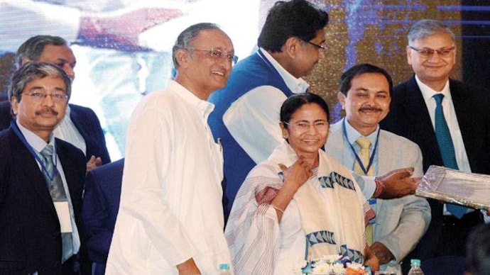 Mamata with FM Amit Mitra at her felicitation ceremony by Chambers of Commerce & Industry. Photo: Subir Halder