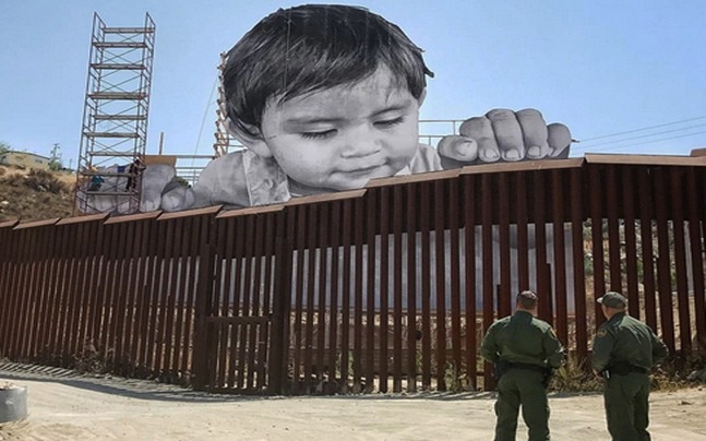 French artist puts huge artwork of boy peeking over US-Mexico border wall