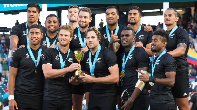 New Zealand's All Blacks pose with World Cup Sevens trophy