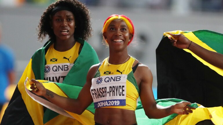 Jamaica's Shelly-Ann Fraser-Pryce and Natalliah Whyte celebrate winning gold at World Athletics Championships.