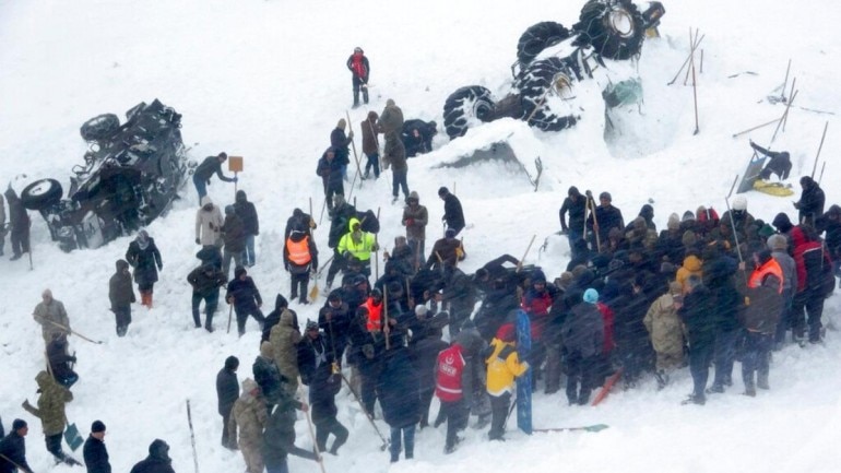 Emergency service members work in the snow around overturned vehicles, near the town of Bahcesaray, Van province, eastern Turkey, Wednesday, Feb. 5, 2020. (Photo: AP)