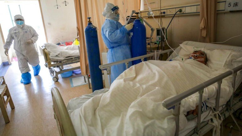 In this Sunday, Feb. 16, 2020, photo, medical workers provide treatment to a new coronavirus patient at a hospital in Wuhan in central China's Hubei province. (Source: AP)