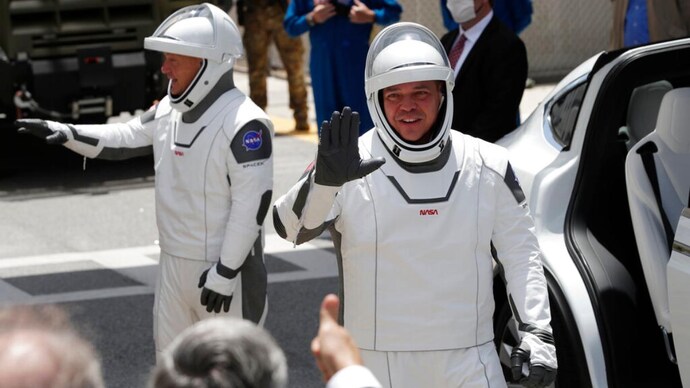 2 Nasa astronauts climb aboard SpaceX rocket for historic launch