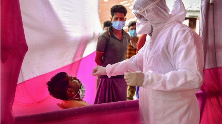 Medic collects a swab sample in Nagaon on May 17