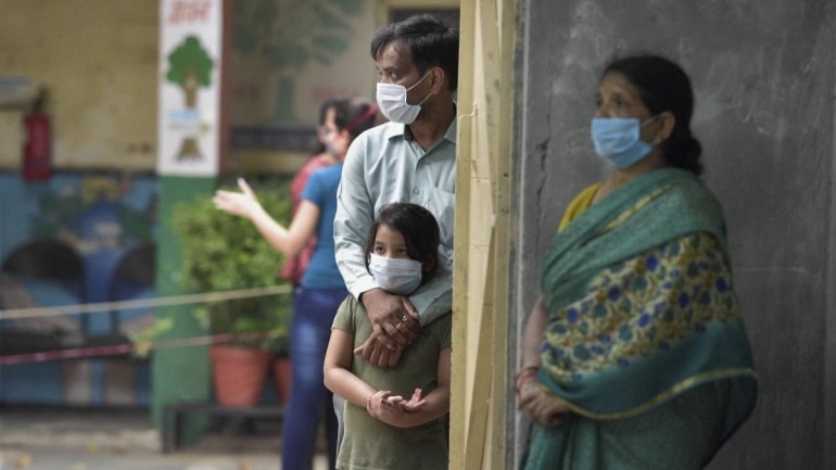Patients wait for their turn to give samples for Covid-19 test at a school on Delhi's Aruna Asaf Ali Road on June 25