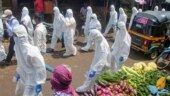 Healthcare workers wearing PPE kits in Mumbai's Ambujwadi area on July 10