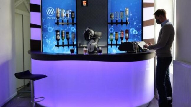 Swiss robot bartender mixes cocktails and tells jokes at bar amid coronavirus pandemic