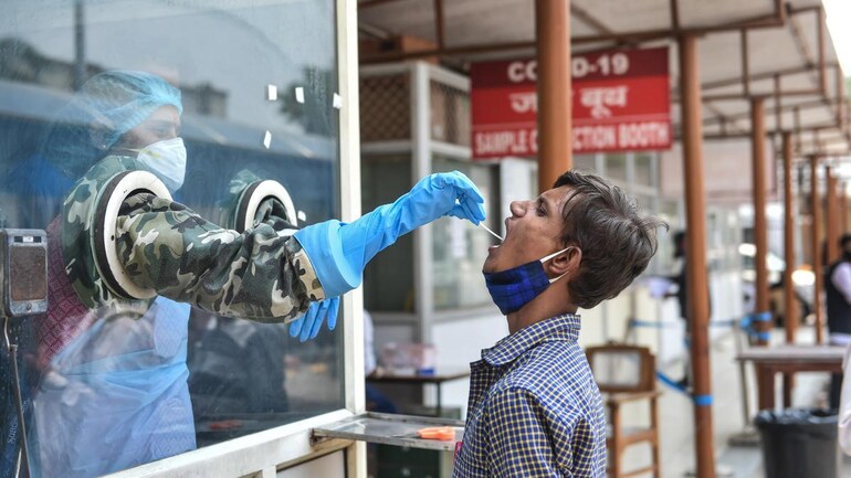 A healthcare worker taking a swab sample for Covid-19 testing at the RML Hospital in Lucknow