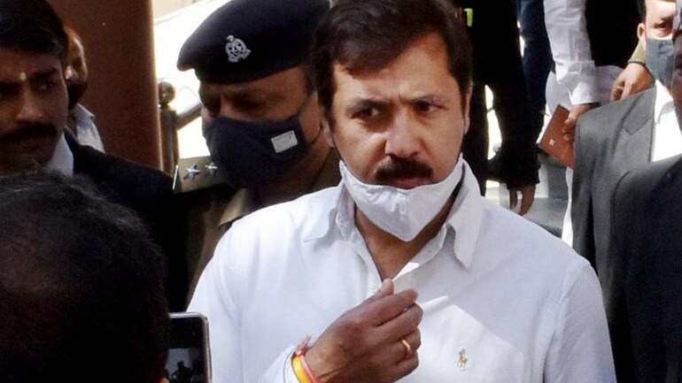 Police personnel accompanying former MP Dhananjay Singh to a court in Prayagraj on March 5, 2021