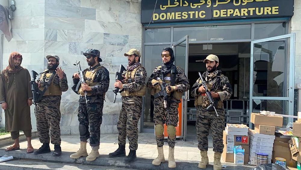 Taliban officials say they will let people who have the proper passports and other documentation leave. Taliban fighters stand guard inside the Hamid Karzai International Airport after the US withdrawal in Kabul. (File photo: AP)