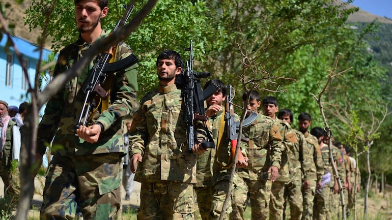 Men with rifles and in military fatigue take part in an exercise in Panjshir