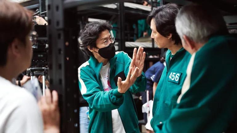 `Squid Game creator Hwang Dong-hyuk with actor Lee Jung-jae on the sets. (Photo: Netflix)