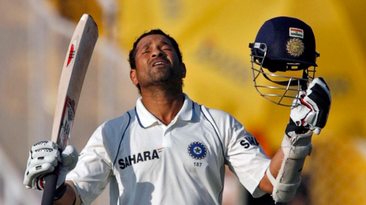 Tendulkar raises his bat after scoring his 43rd Test century. 