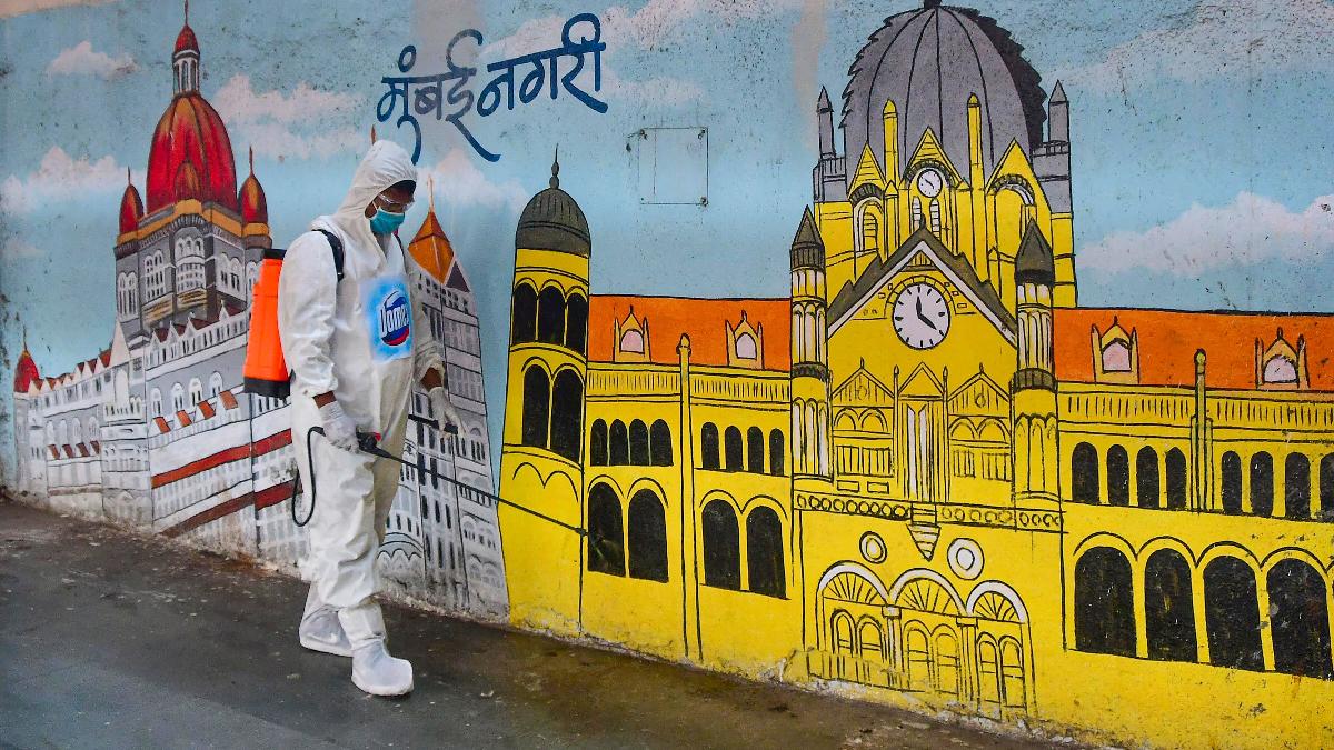 A worker wearing a PPE kit sprays disinfectant at a platform in Chhatrapati Shivaji Terminus, Mumbai. (File photo)