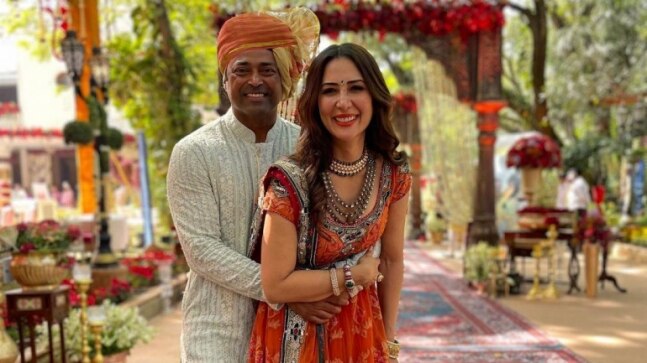 Kim Sharma and Leander Paes are all smiles as they pose together at a wedding. See here
